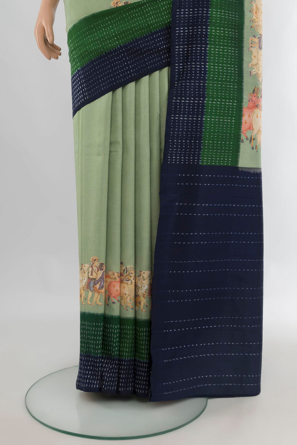 Pleats and pallu of Pure Silk Light Green Printed Saree with Plain Body and Ikat Border. 