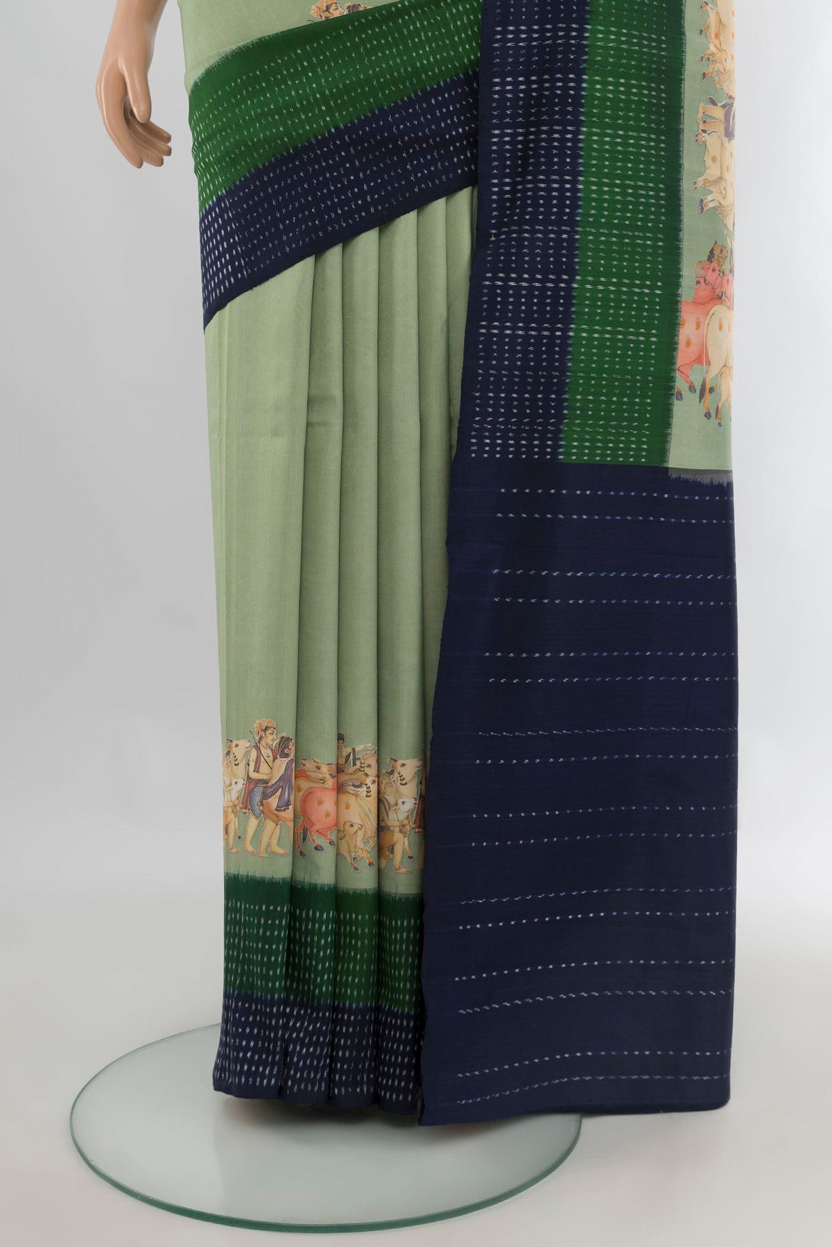 Pleats and pallu of Pure Silk Light Green Printed Saree with Plain Body and Ikat Border. 