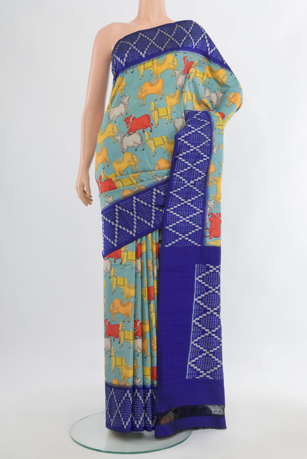 Pure Silk Light Blue Printed Saree with Printed design on the body and Ikat Border.  displayed on a mannequin