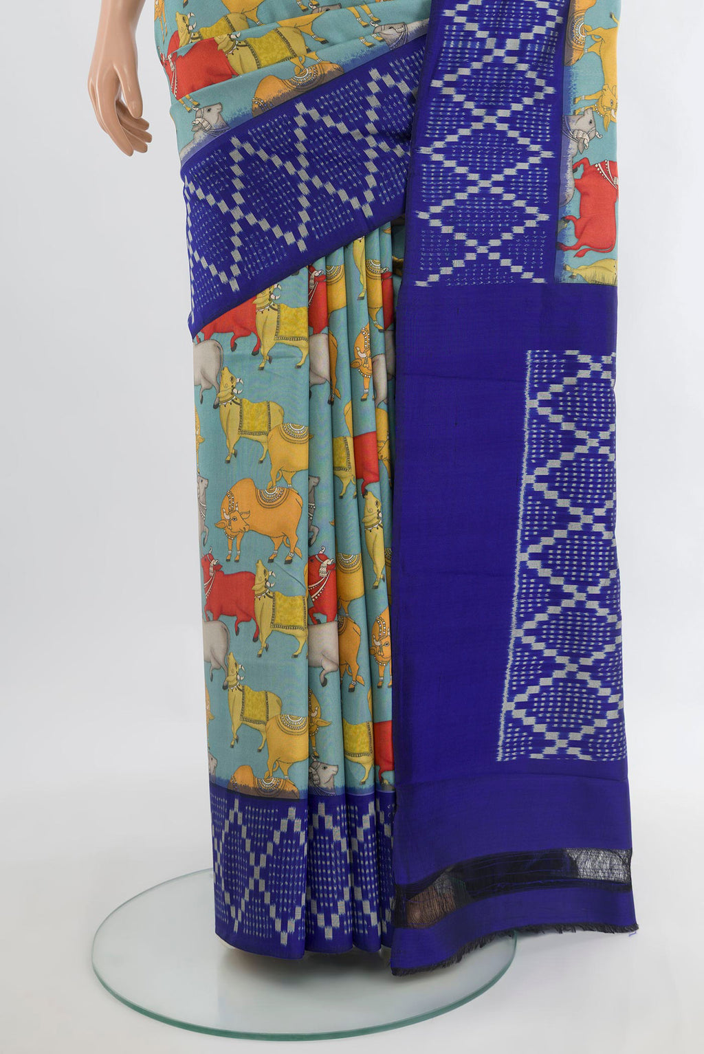 Pleats and pallu of Pure Silk Light Blue Printed Saree with Printed design on the body and Ikat Border. 