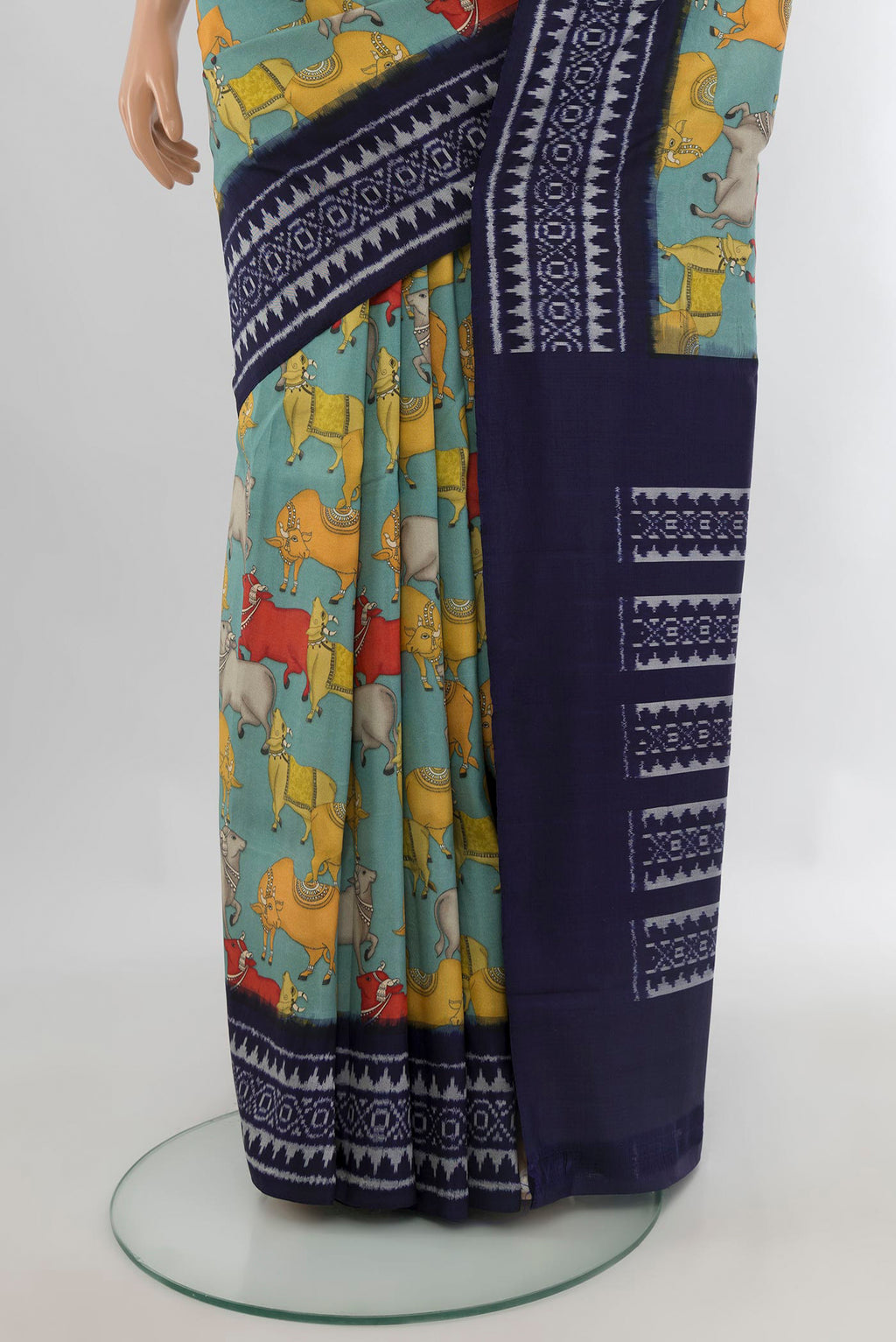 Pleats and pallu of Pure Silk Light Blue Printed Saree with Printed design on the body and Ikat Border. 