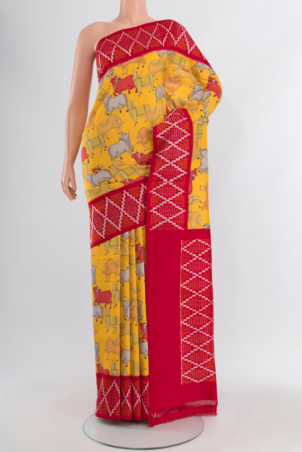 Yellow Printed Silk Saree with Floral Print on the body and Ikat Border.  displayed on a mannequin