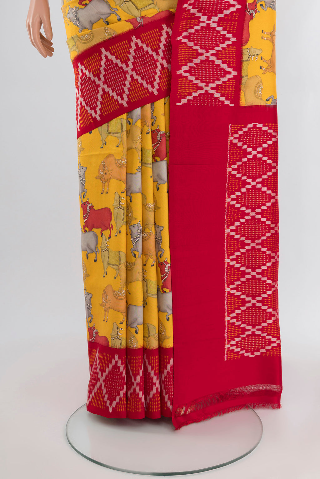 Pleats and pallu of Yellow Printed Silk Saree with Floral Print on the body and Ikat Border. 