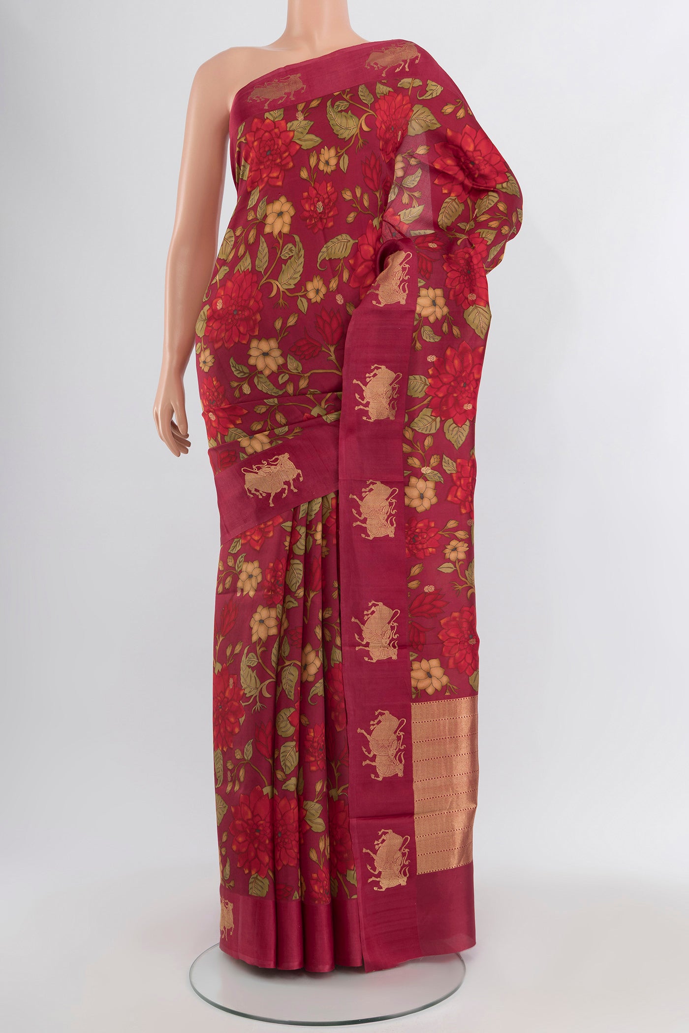 Maroon Banarasi Katan Silk Saree with Floral Print on the body and Fancy Border.  displayed on a mannequin