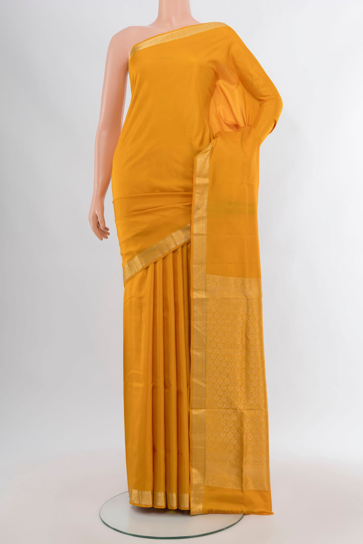 Mustard Soft Silk Saree with Plain Body and Zari Border.  displayed on a mannequin