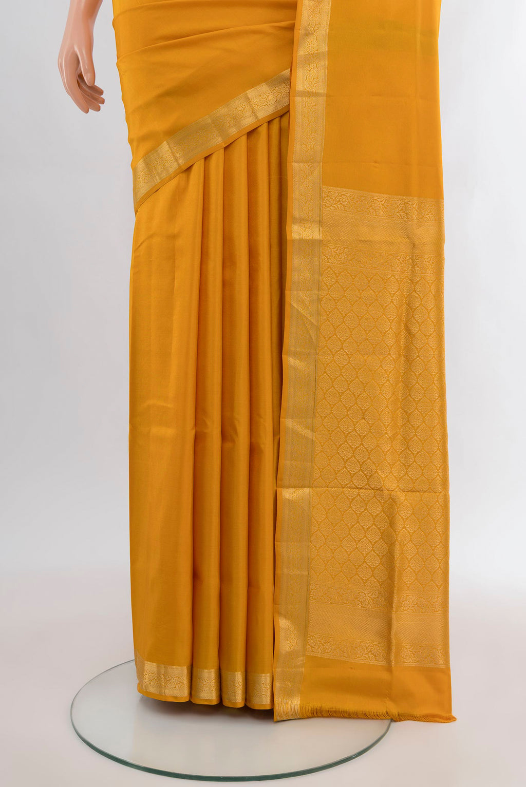 Pleats and pallu of Mustard Soft Silk Saree with Plain Body and Zari Border. 