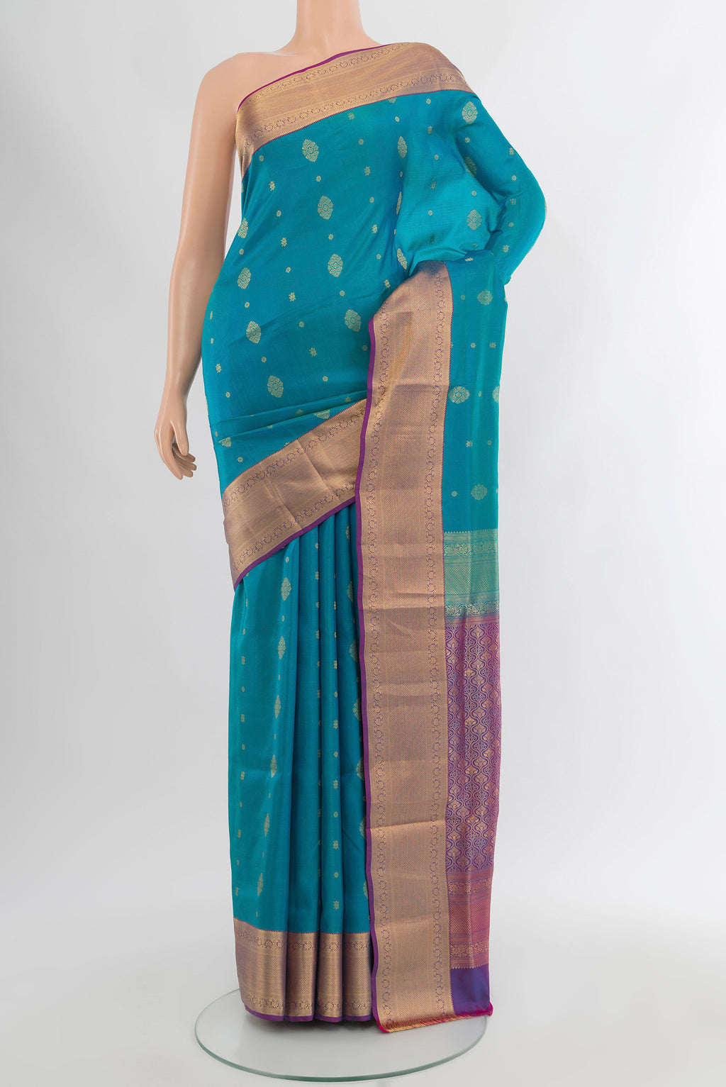 Light Blue Soft Silk Saree with Zari Butta on the body and Zari Border.  displayed on a mannequin