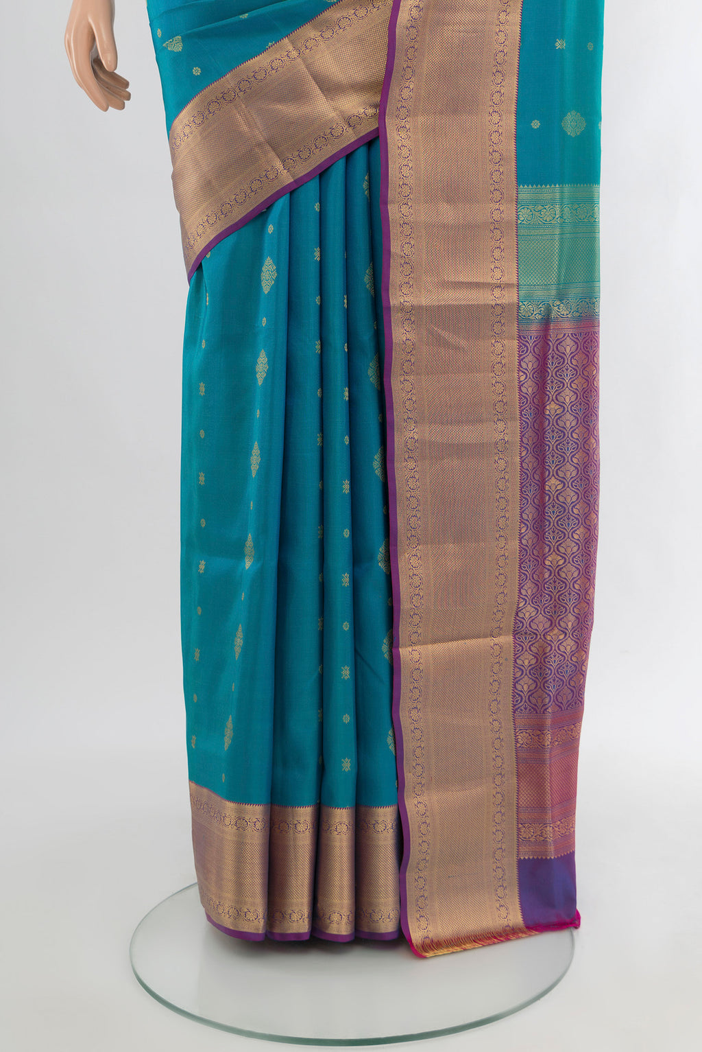 Pleats and pallu of Light Blue Soft Silk Saree with Zari Butta on the body and Zari Border. 