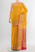Mustard Soft Silk Saree with Zari Butta on the body and Silk Border.  displayed on a mannequin
