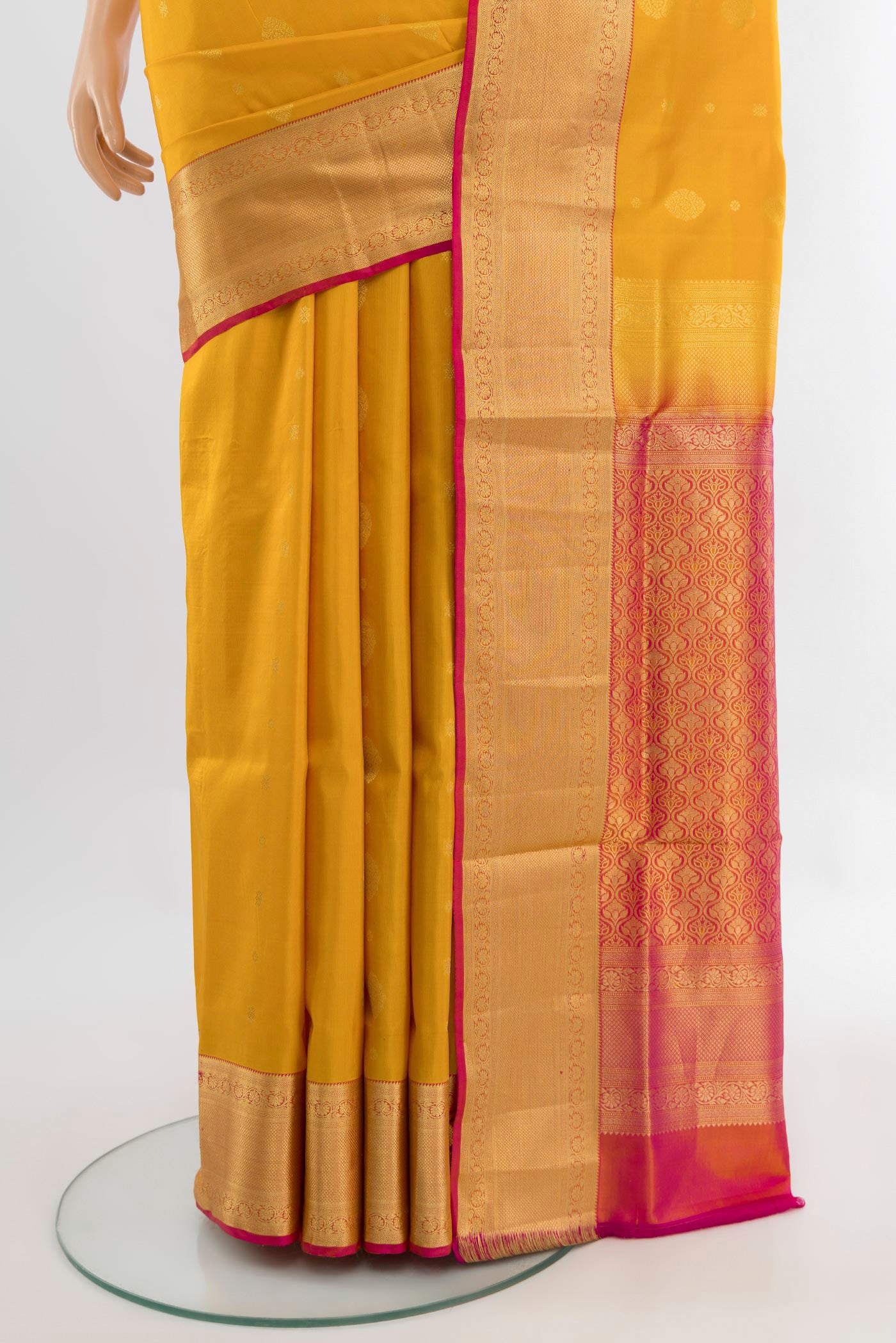 Pleats and pallu of Mustard Soft Silk Saree with Zari Butta on the body and Silk Border. 