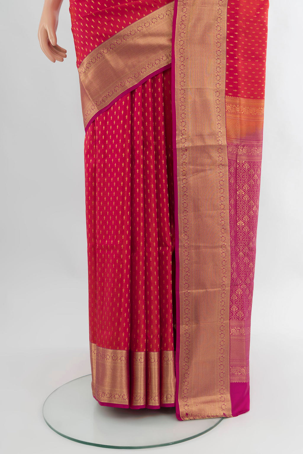 Pleats and pallu of Coral Soft Silk Saree with Zari Butta on the body and Zari Border. 