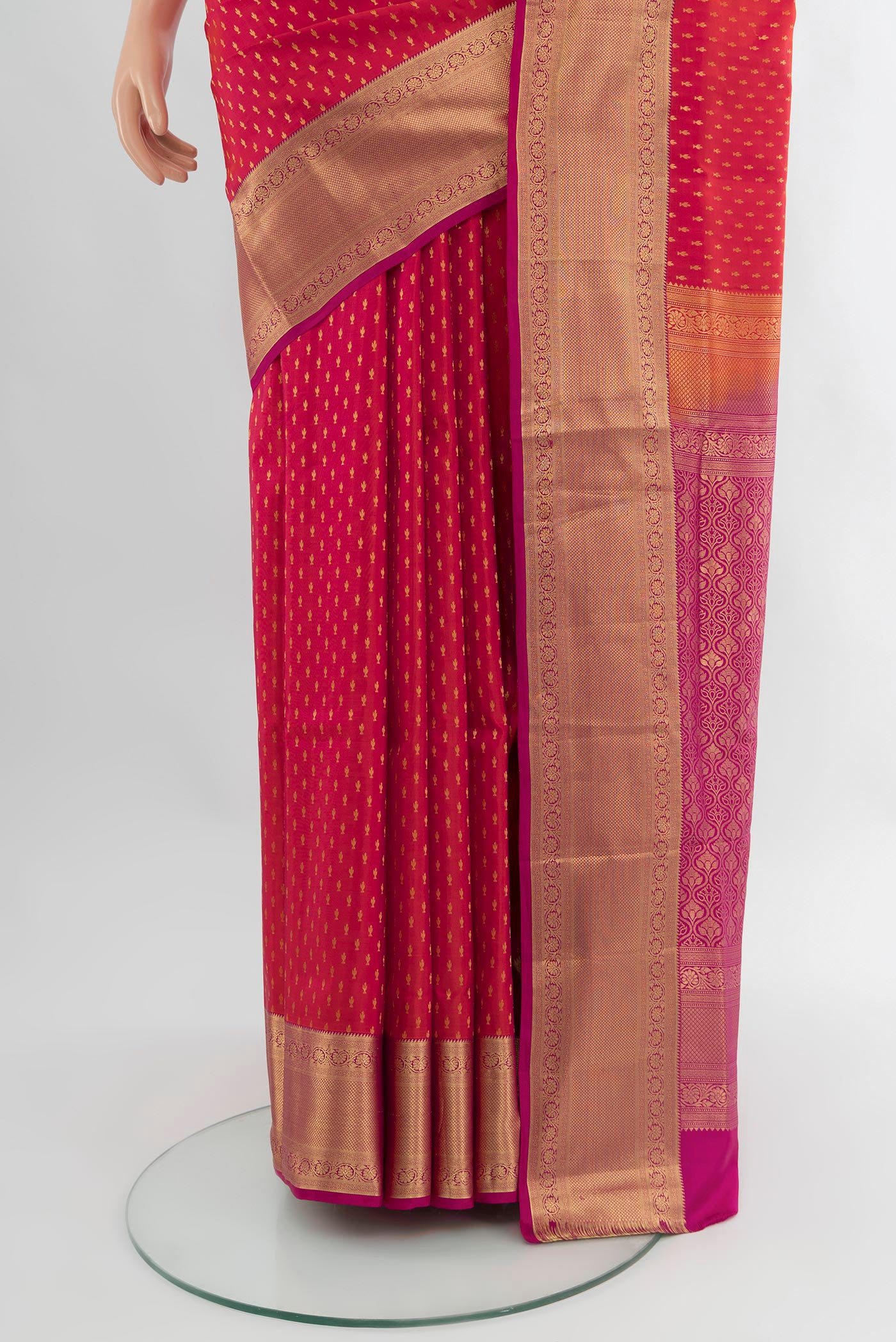 Pleats and pallu of Coral Soft Silk Saree with Zari Butta on the body and Zari Border. 