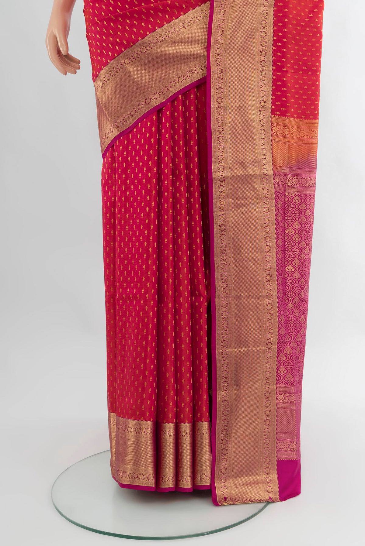 Pleats and pallu of Coral Soft Silk Saree with Zari Butta on the body and Zari Border. 