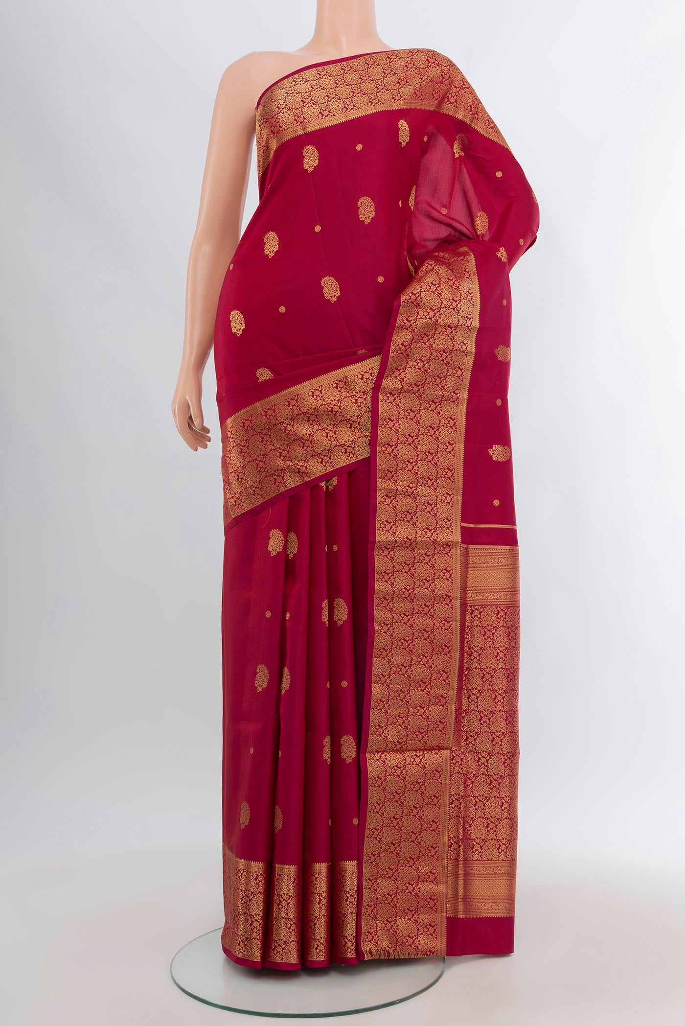 Maroon Soft Silk Saree with Zari Butta on the body and Zari Border.  displayed on a mannequin
