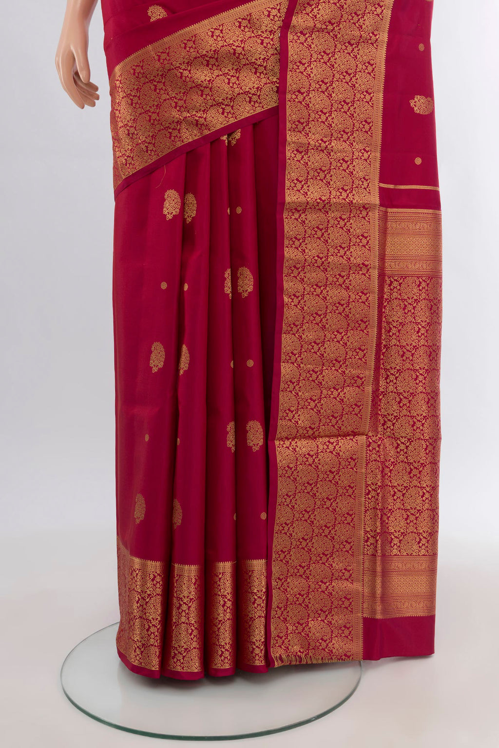 Pleats and pallu of Maroon Soft Silk Saree with Zari Butta on the body and Zari Border. 