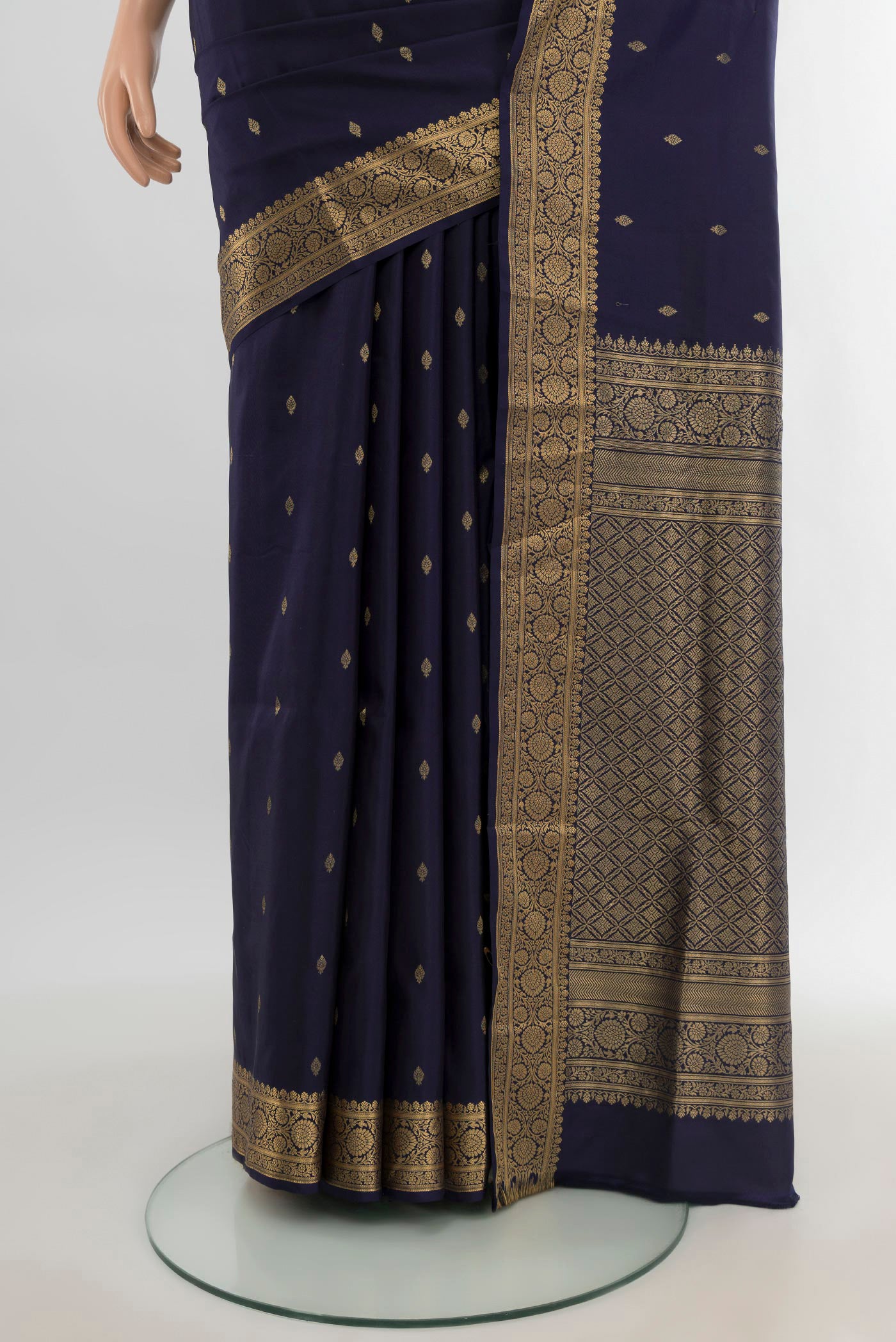 Pleats and pallu of Navy Blue Soft Silk Saree with Zari Butta on the body and Zari Border. 