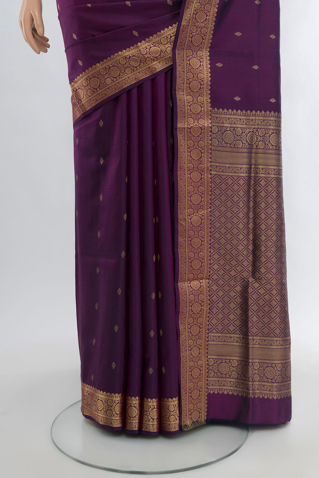 Pleats and pallu of Purple Soft Silk Saree with Zari Butta on the body and Zari Border. 