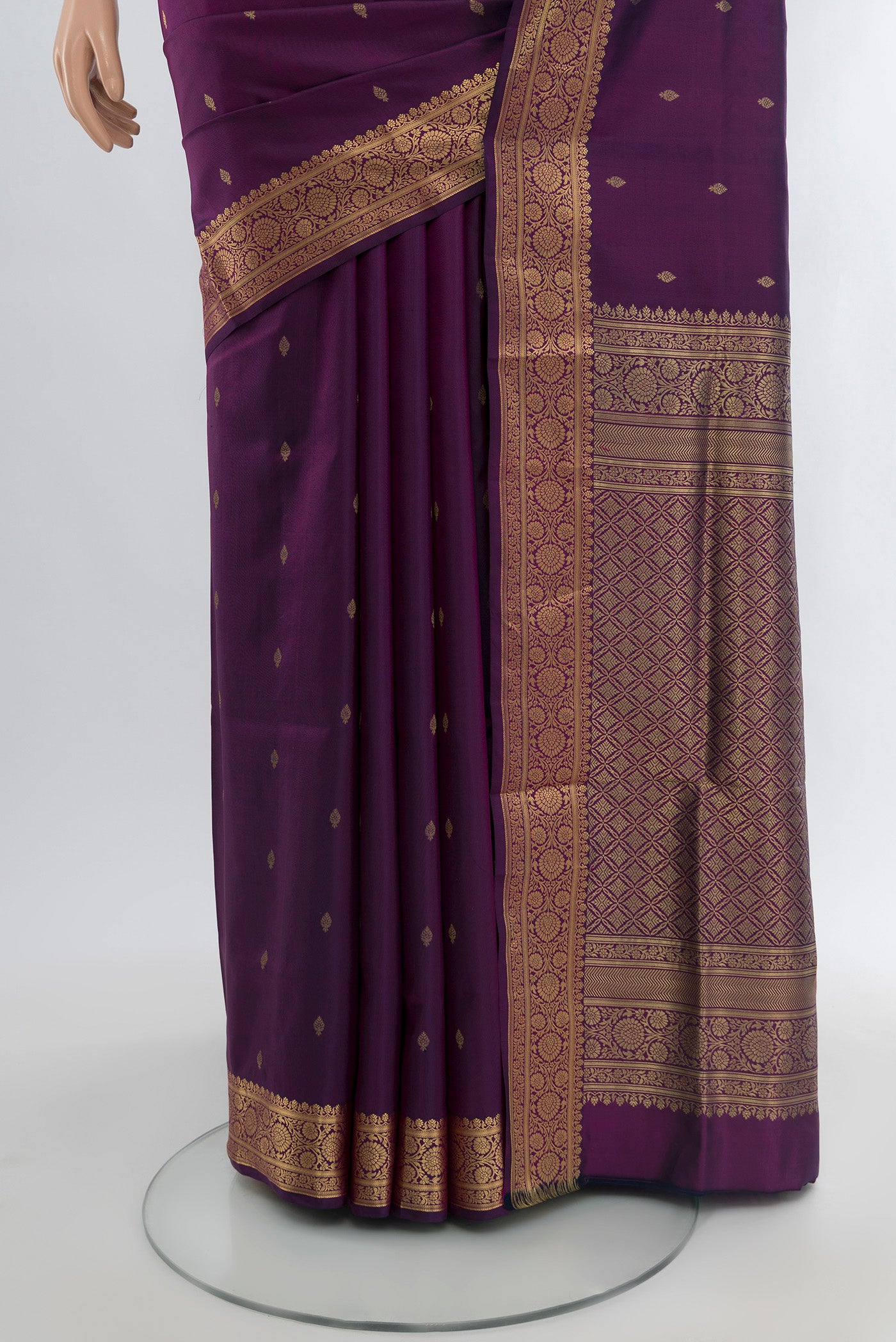 Pleats and pallu of Purple Soft Silk Saree with Zari Butta on the body and Zari Border. 