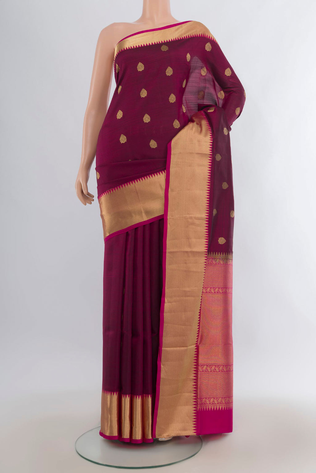Pure Silk Maroon Soft Saree with Zari Butta on the body and Zari Border.  displayed on a mannequin
