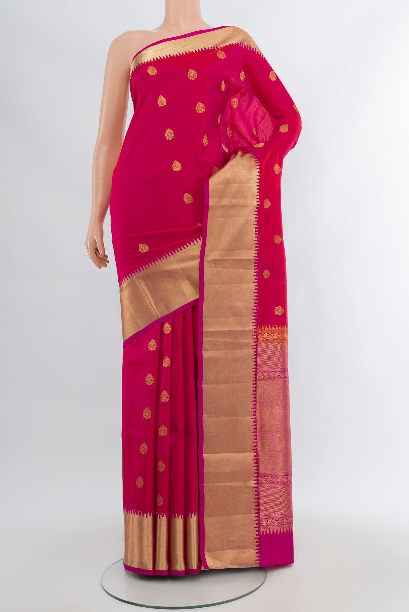 Pink Kanjivaram Silk Saree with Zari Butta on the body and Zari Border.  displayed on a mannequin