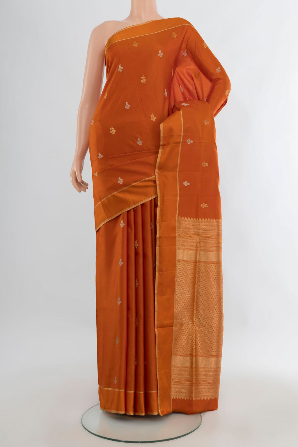 Pure Silk Rust Soft Saree with Zari Butta on the body and Plain Border.  displayed on a mannequin