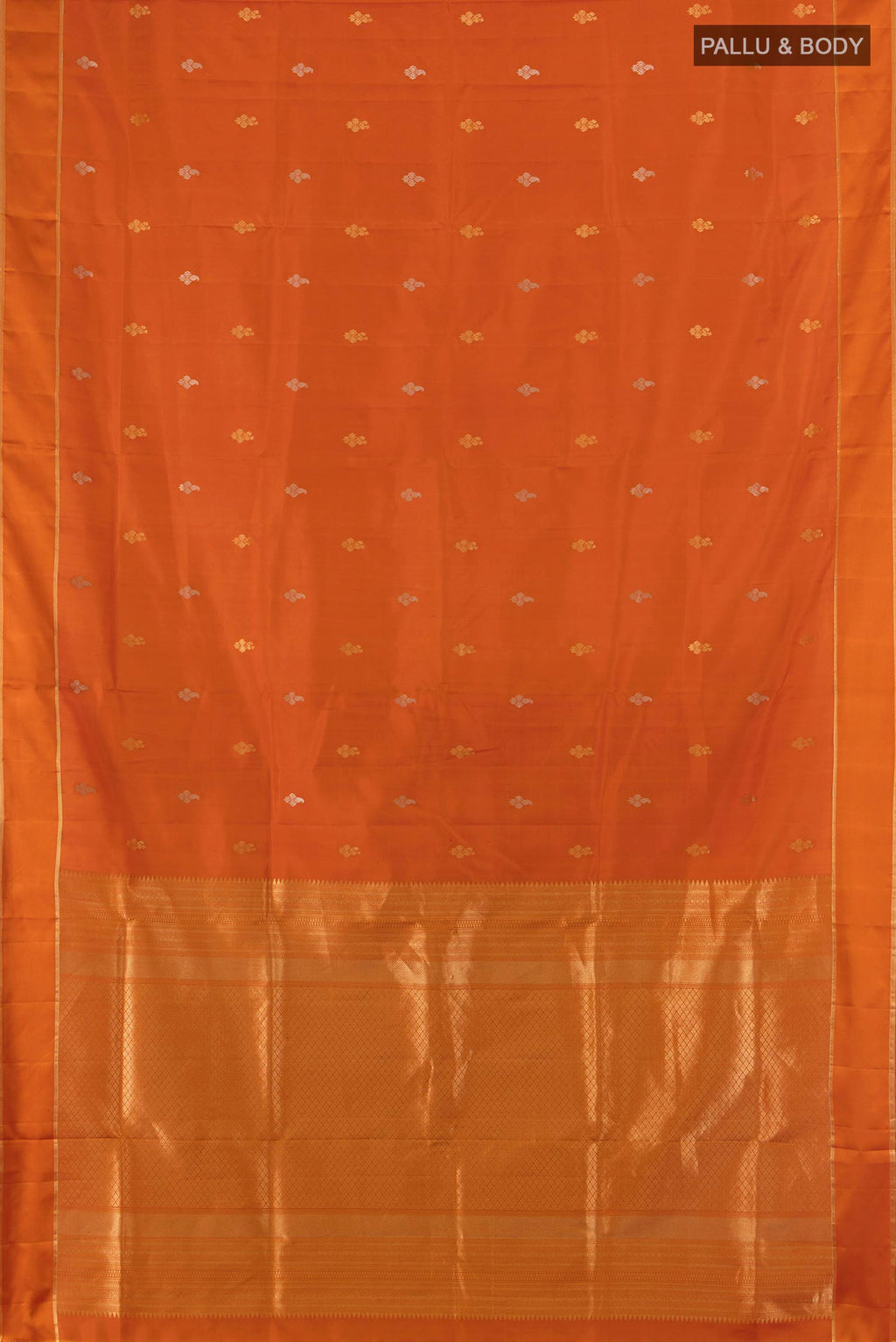 Flat view of Pure Silk Rust Soft Saree with Zari Butta on the body and Plain Border. 