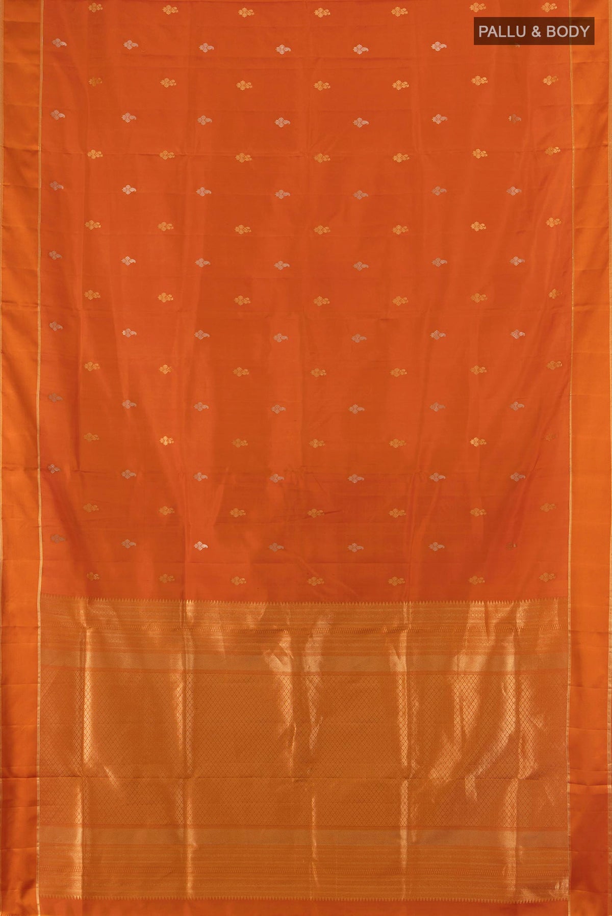 Flat view of Pure Silk Rust Soft Saree with Zari Butta on the body and Plain Border. 