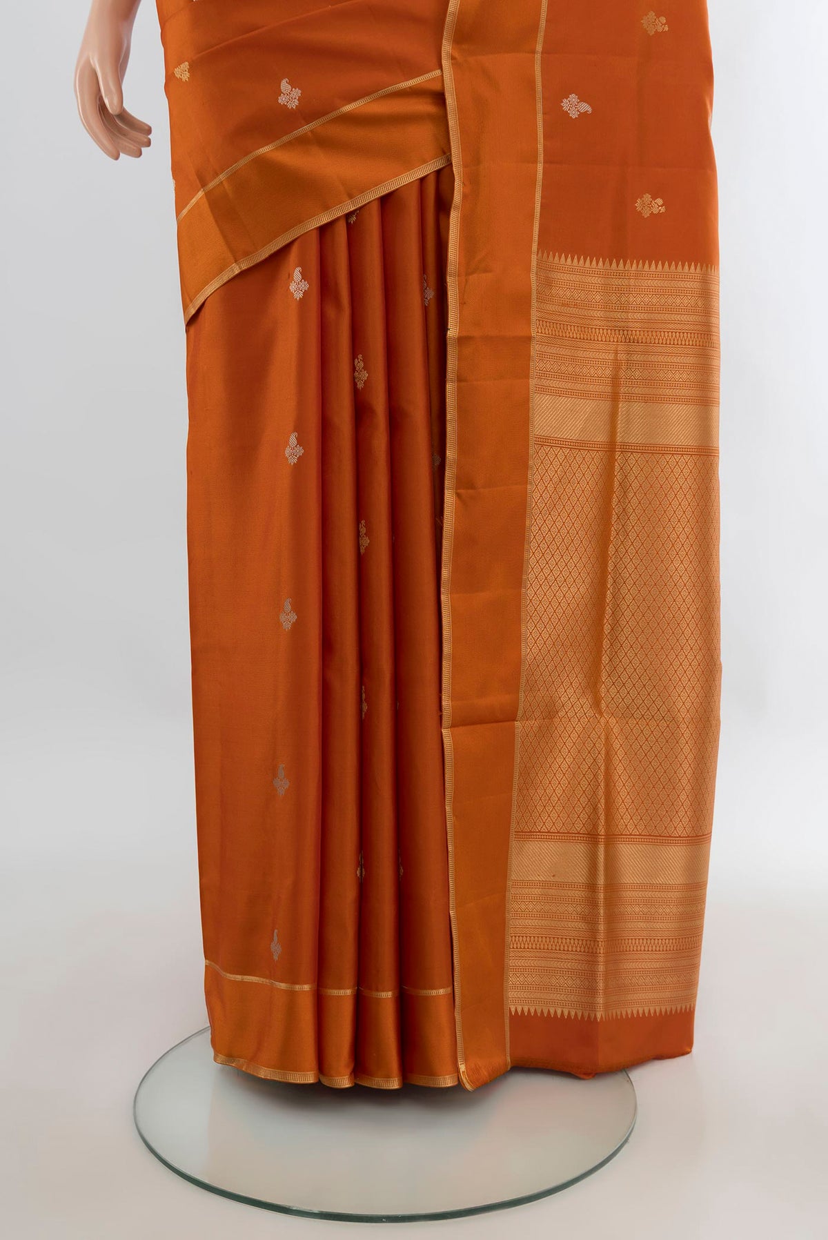 Pleats and pallu of Pure Silk Rust Soft Saree with Zari Butta on the body and Plain Border. 