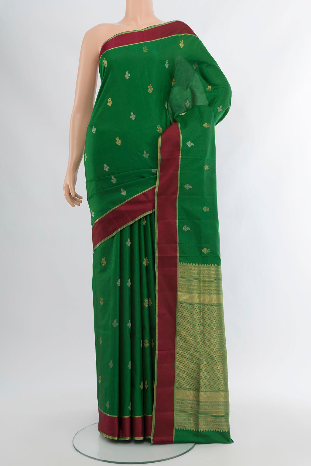 Green Soft Silk Saree with Zari Butta on the body and Plain Border.  displayed on a mannequin