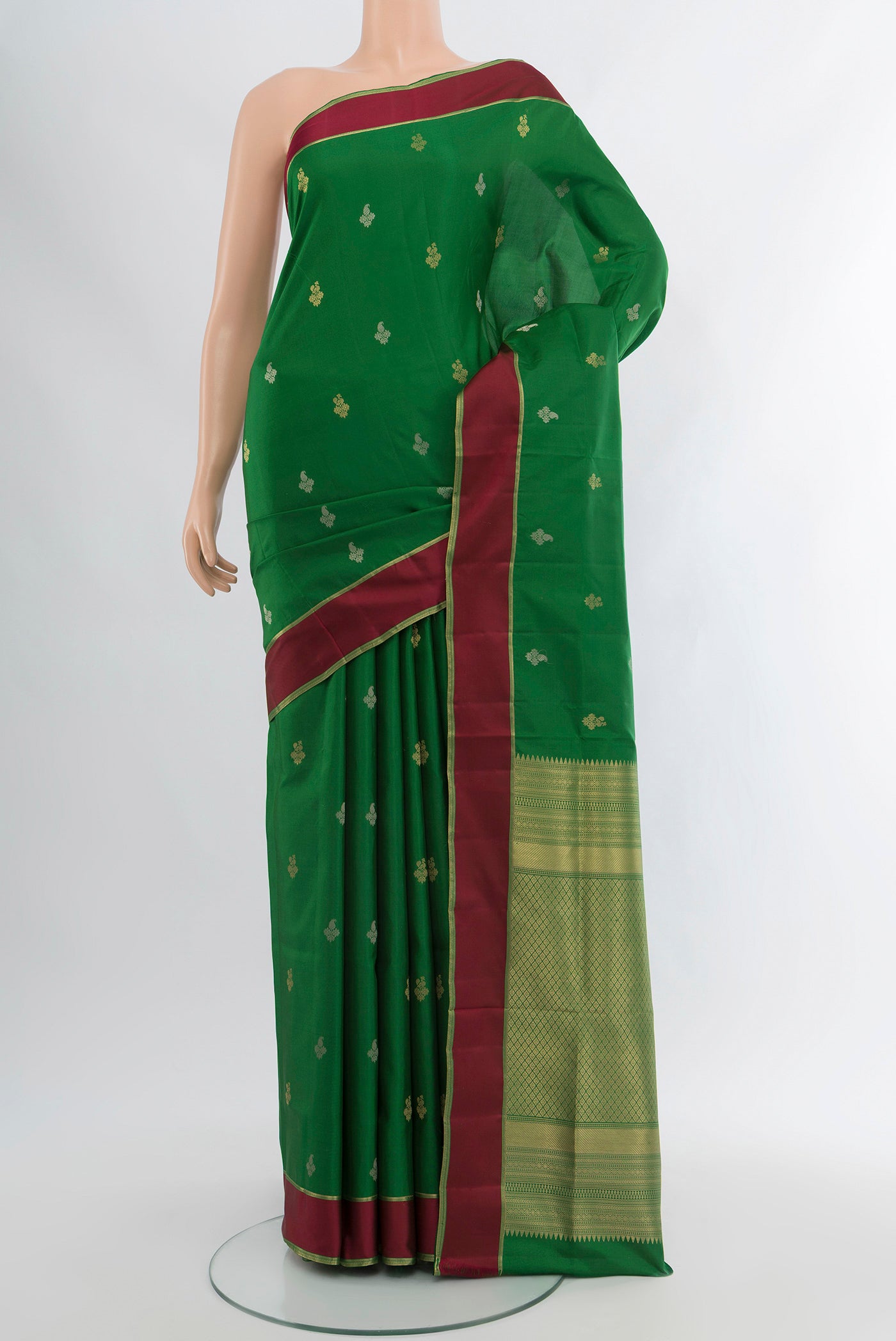Green Soft Silk Saree with Zari Butta on the body and Plain Border.  displayed on a mannequin