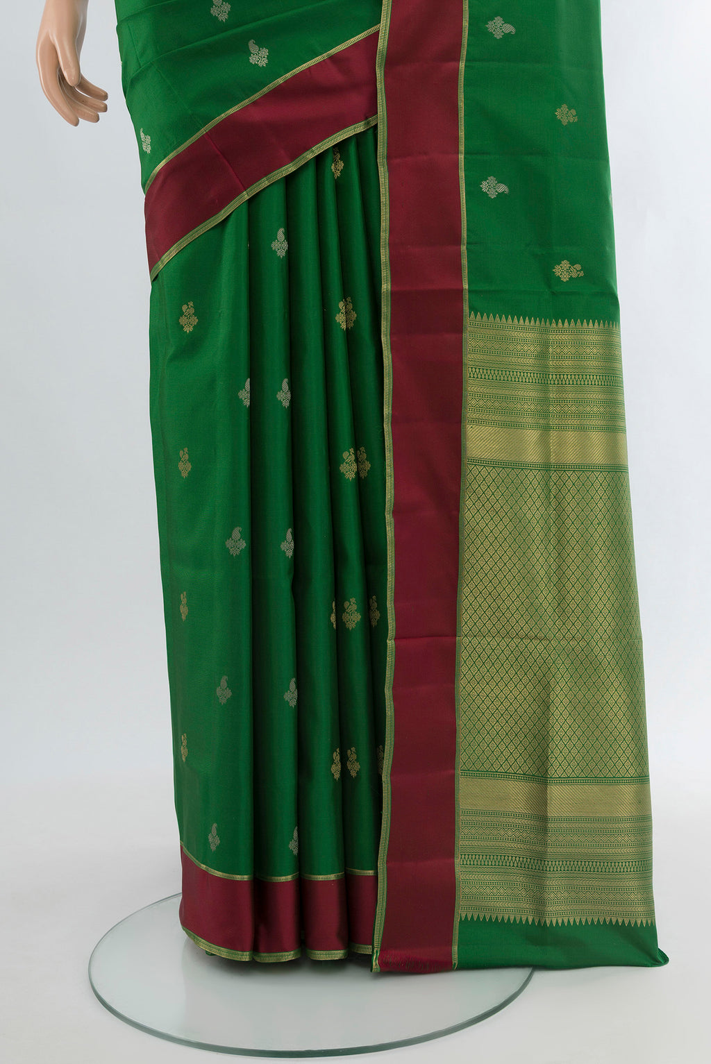 Pleats and pallu of Green Soft Silk Saree with Zari Butta on the body and Plain Border. 