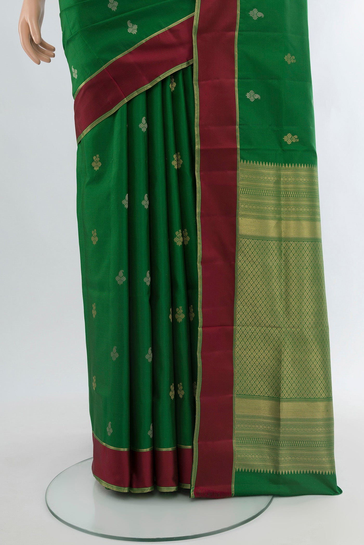 Pleats and pallu of Green Soft Silk Saree with Zari Butta on the body and Plain Border. 