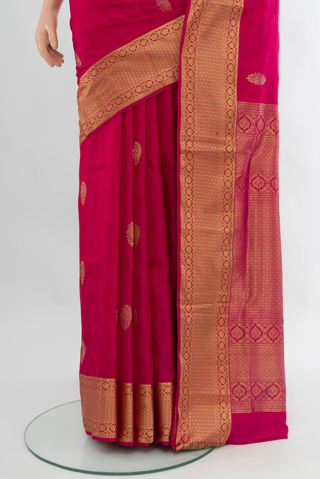Pleats and pallu of Pink Soft Silk Saree with Zari Butta on the body and Zari Border. 