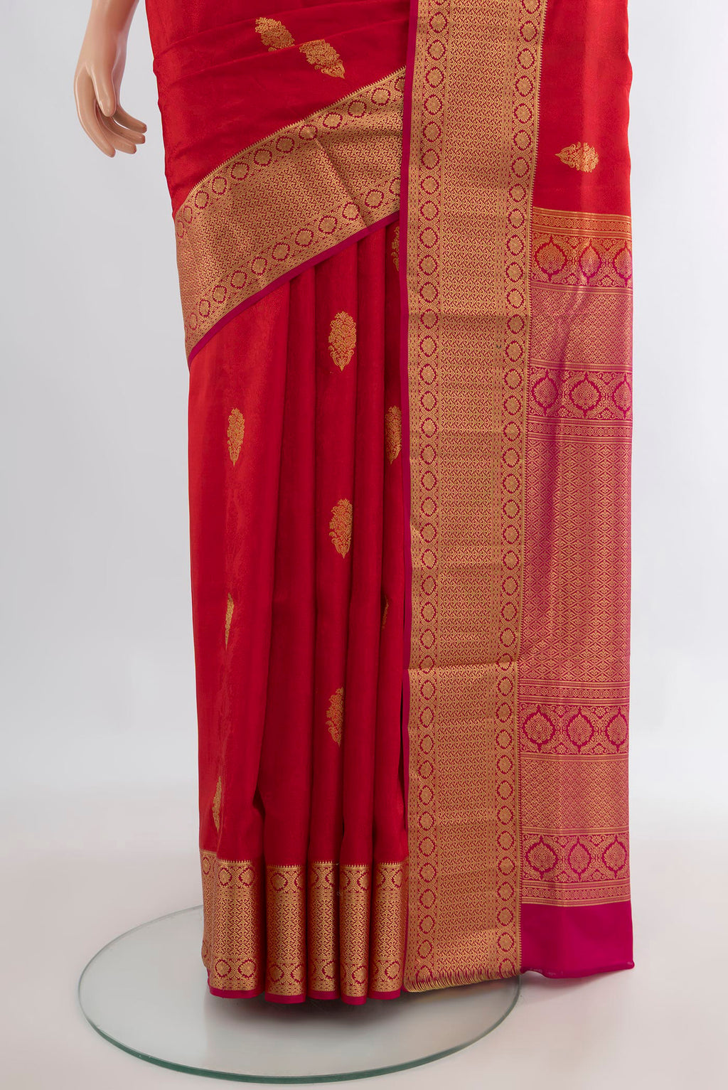 Pleats and pallu of Pure Silk Red Soft Saree with Zari Butta on the body and Zari Border. 