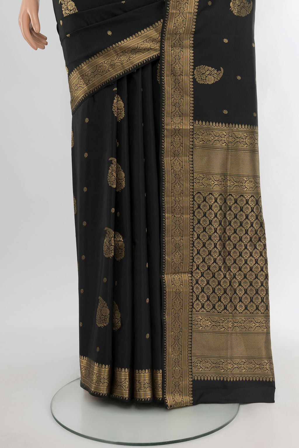 Pleats and pallu of Black Soft Silk Saree with Zari Butta on the body and Zari Border. 