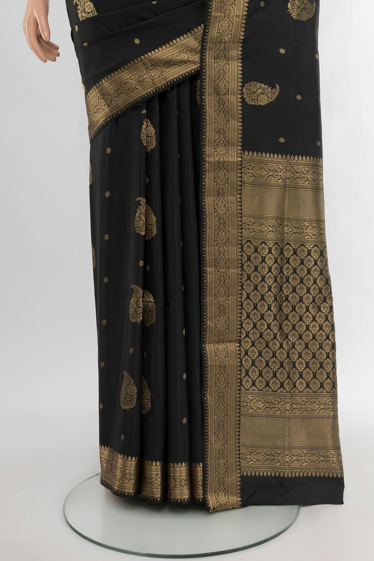 Pleats and pallu of Black Soft Silk Saree with Zari Butta on the body and Zari Border. 