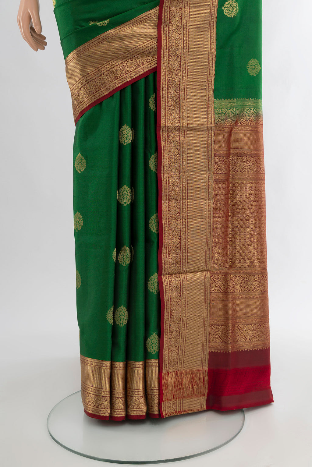 Pleats and pallu of Green Soft Silk Saree with Zari Butta on the body and Zari Border. 