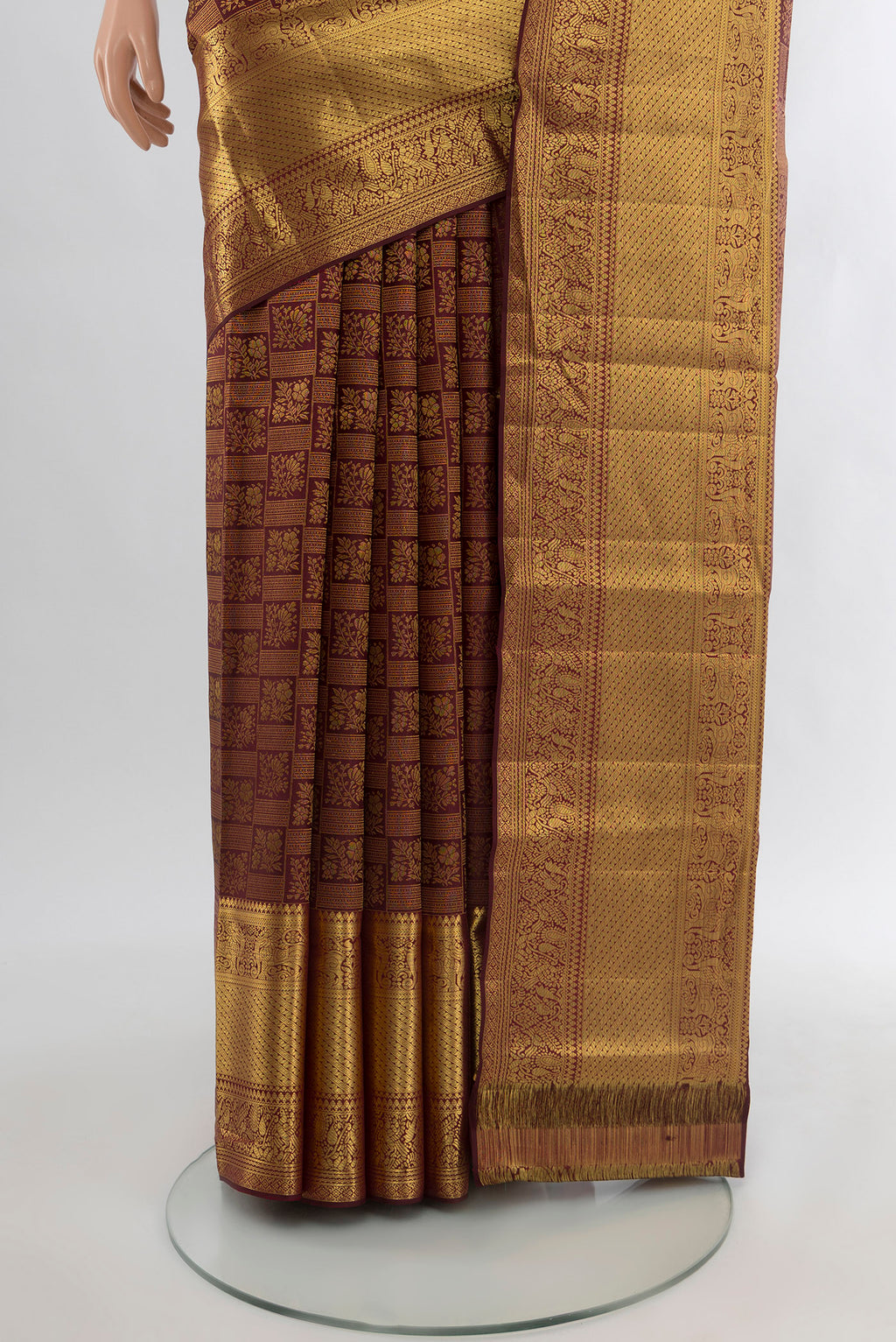 Pleats and pallu of Pure Silk Pure Zari Coffee Brown Kanchipuram Saree with Zari Butta on the body and Silk Border. 