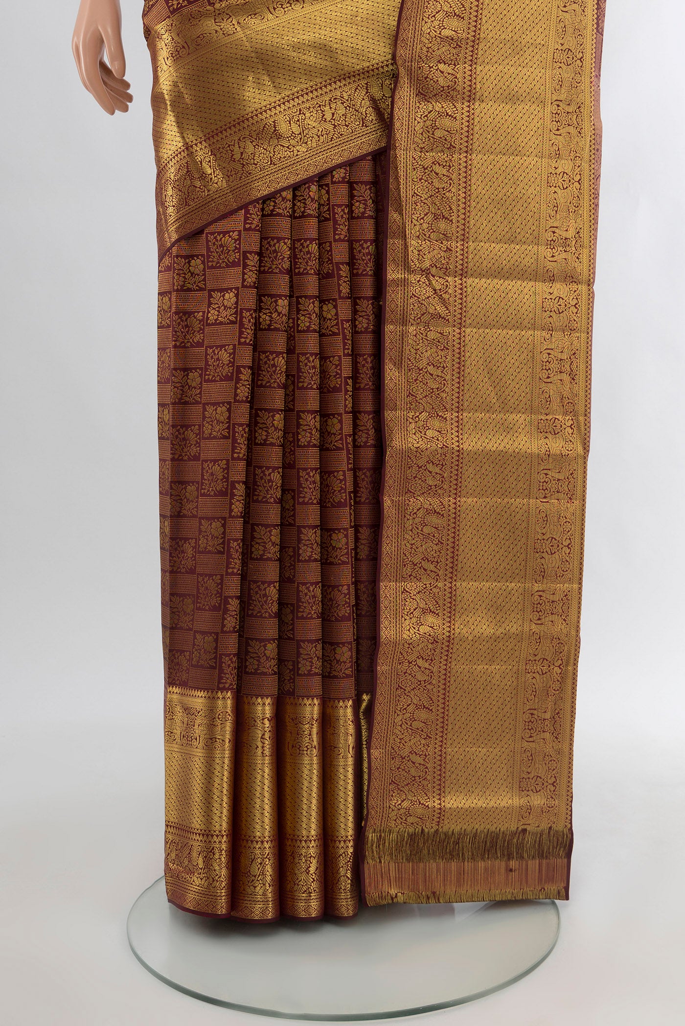 Pleats and pallu of Pure Silk Pure Zari Coffee Brown Kanchipuram Saree with Zari Butta on the body and Silk Border. 