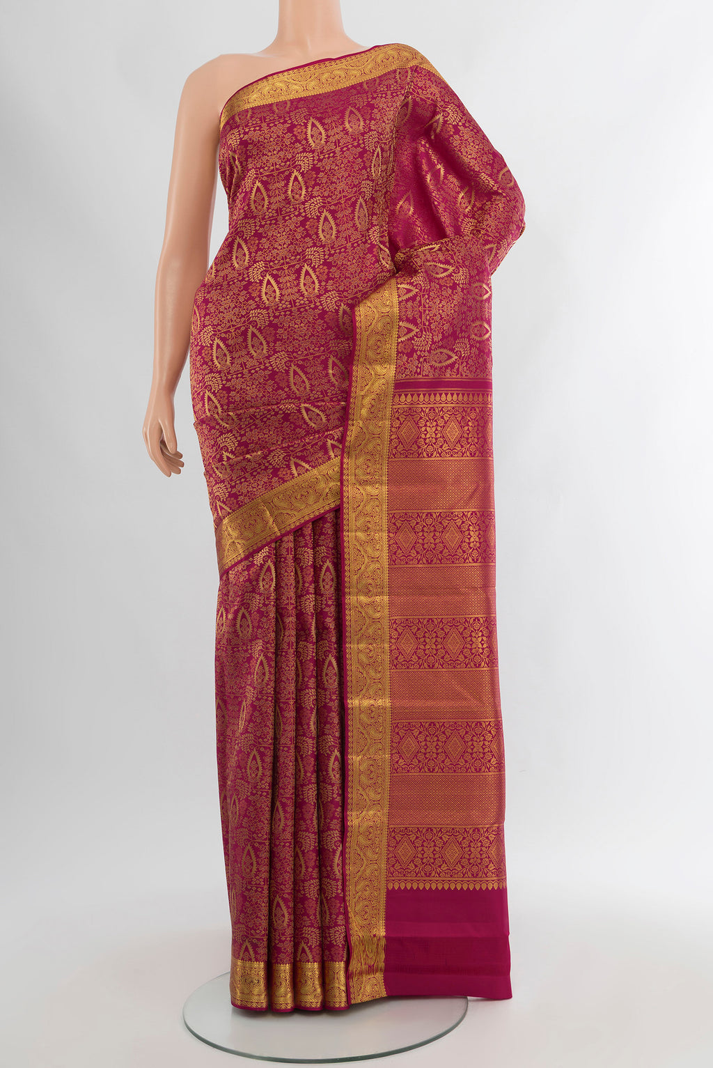 Dark Pink Kanchipuram Silk Saree with Zari Brocade on the body and Zari Border.  displayed on a mannequin