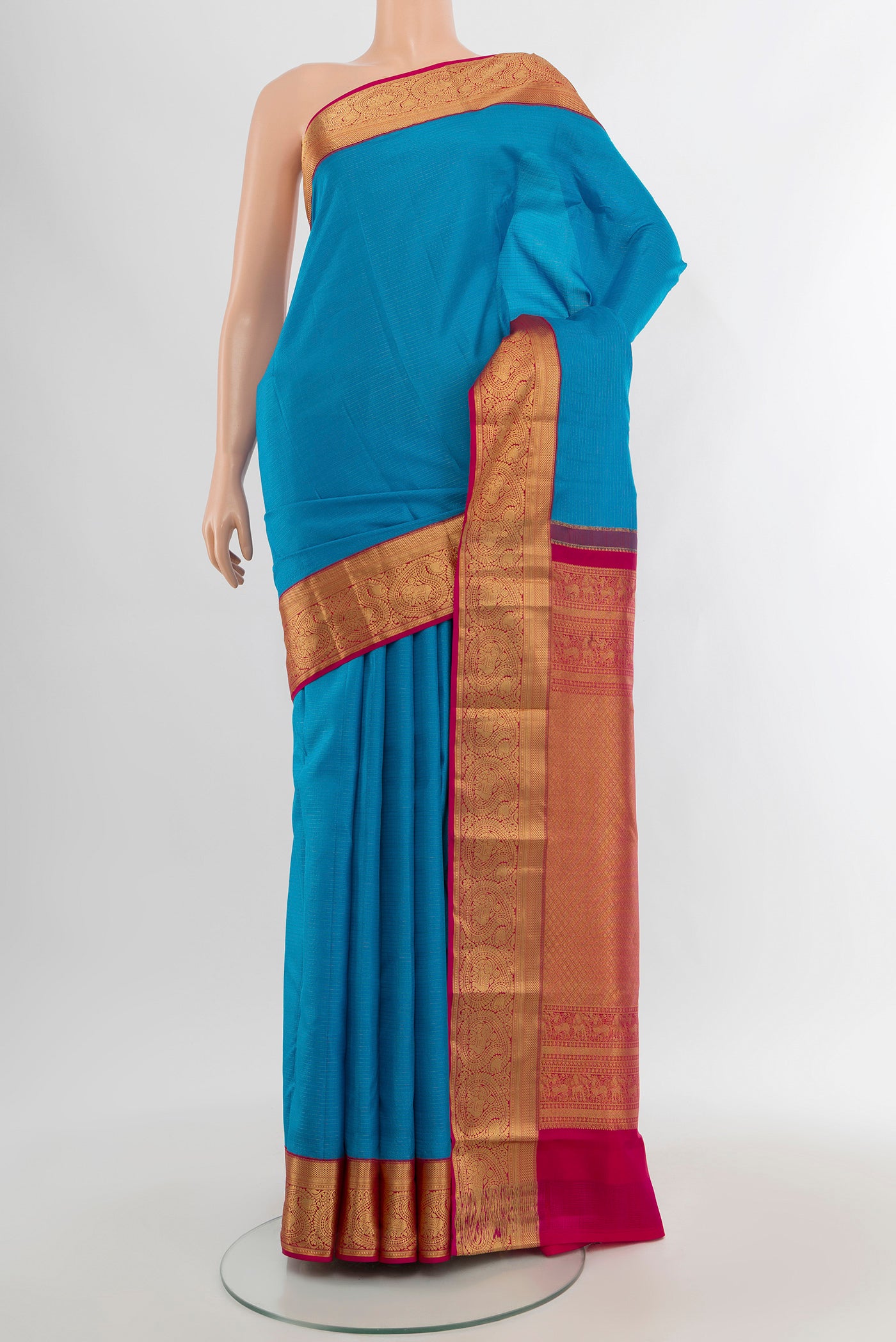 Blue Kanchipuram Silk Saree with Plain Body and Zari Border.  displayed on a mannequin