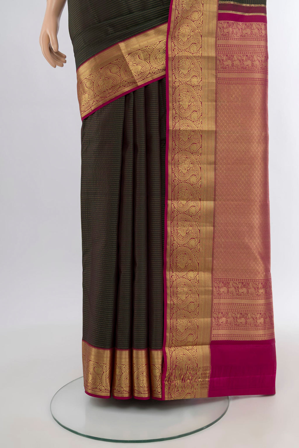 Pleats and pallu of Bottle Green Kanchipuram Silk Saree with Stripes on the body and Zari Border. 