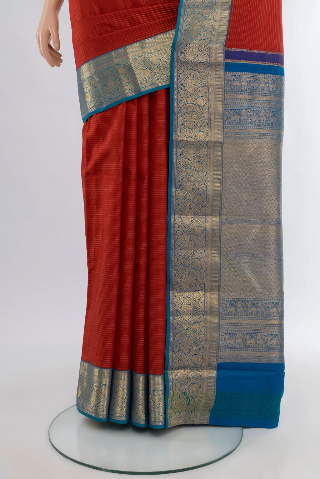 Pleats and pallu of Maroon Kanchipuram Silk Saree with Stripes on the body and Zari Border. 