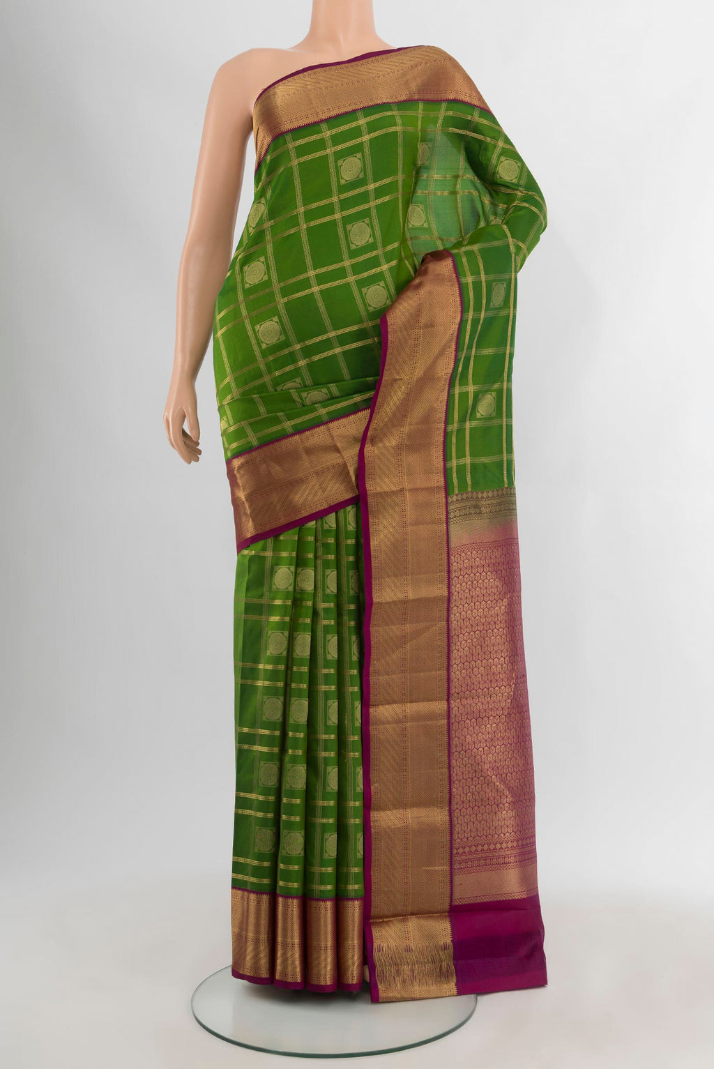 Green Kanchipuram Silk Saree with Checked design on the body and Zari Border.  displayed on a mannequin