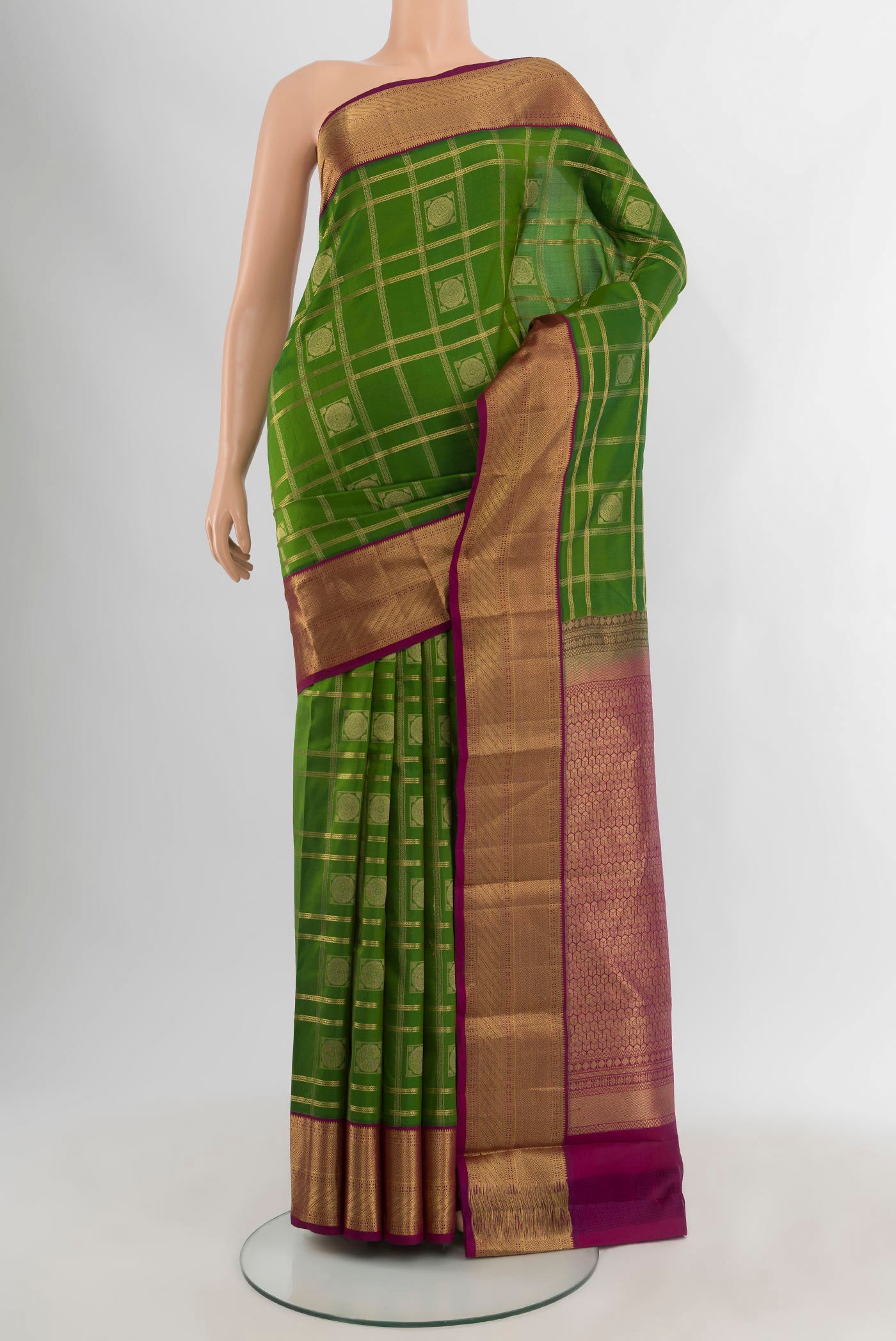 Green Kanchipuram Silk Saree with Checked design on the body and Zari Border.  displayed on a mannequin