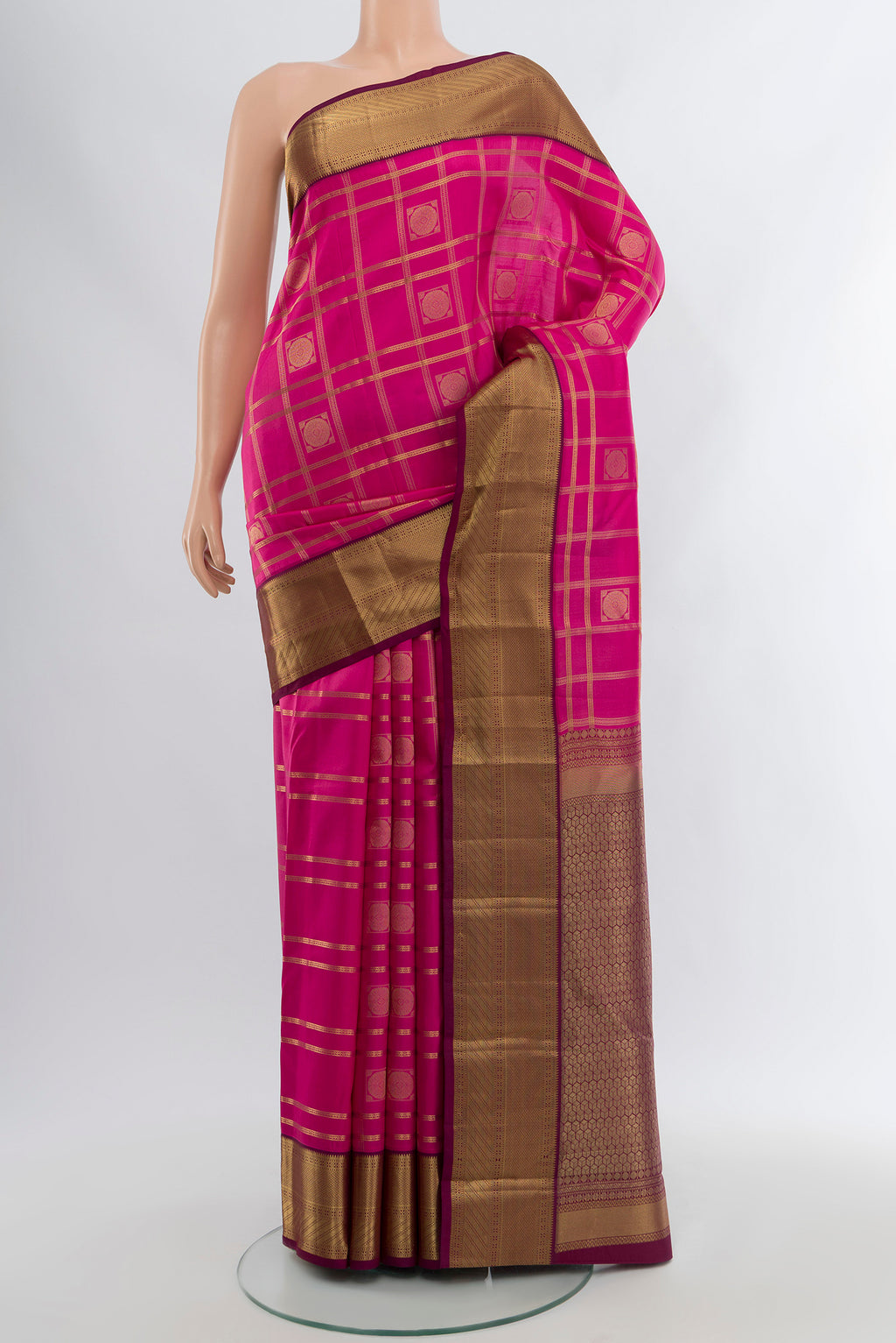 Pink Kanchipuram Silk Saree with Checked design on the body and Zari Border.  displayed on a mannequin