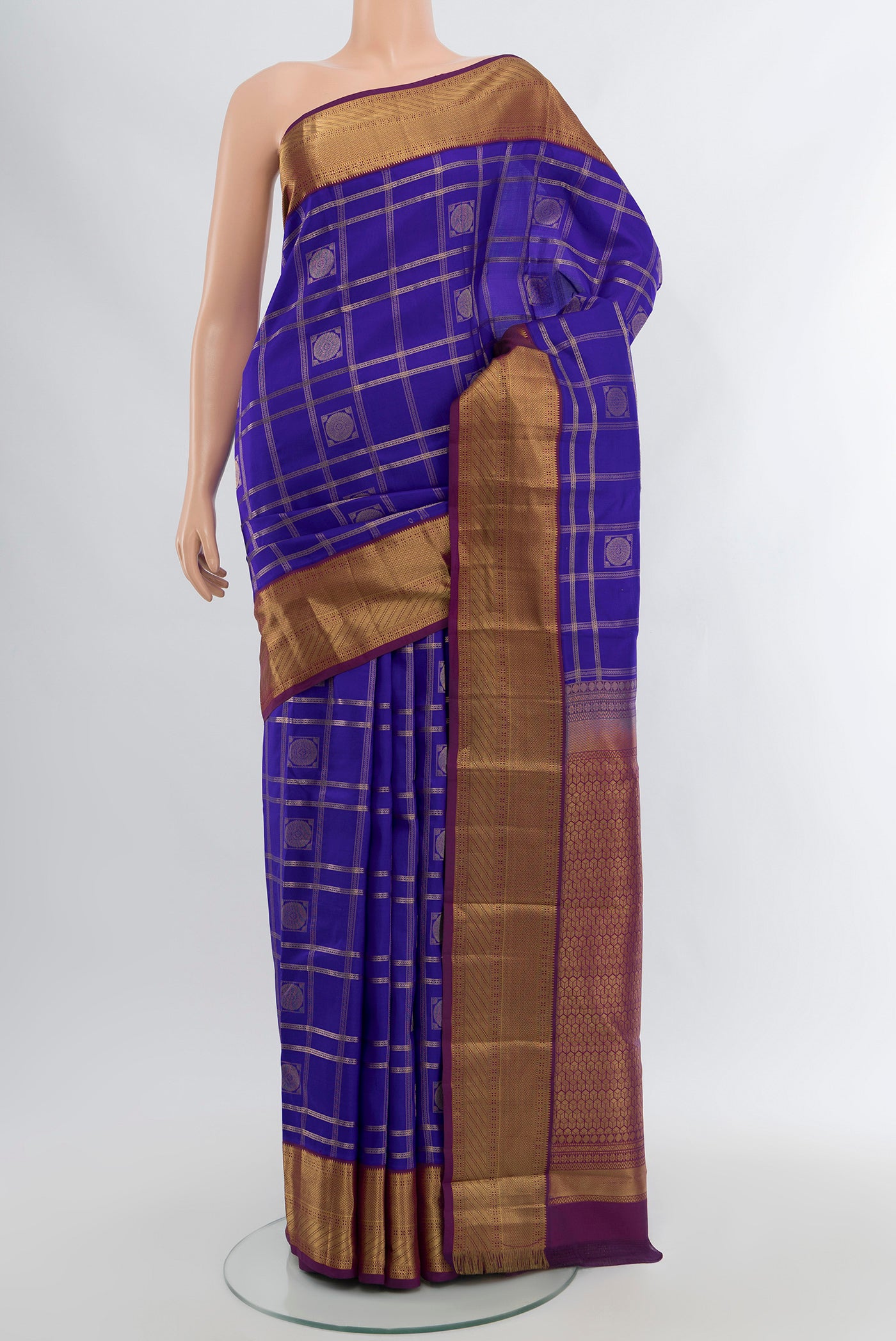 Royal Blue Kanchipuram Silk Saree with Checked design on the body and Zari Border.  displayed on a mannequin