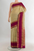 Pure Silk Beige Kanchipuram Saree with Plain Body and Zari Border.  displayed on a mannequin