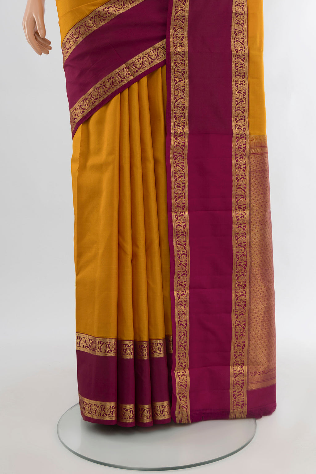 Pleats and pallu of Mustard Kanchipuram Silk Saree with Zari Butta on the body and Silk Border. 
