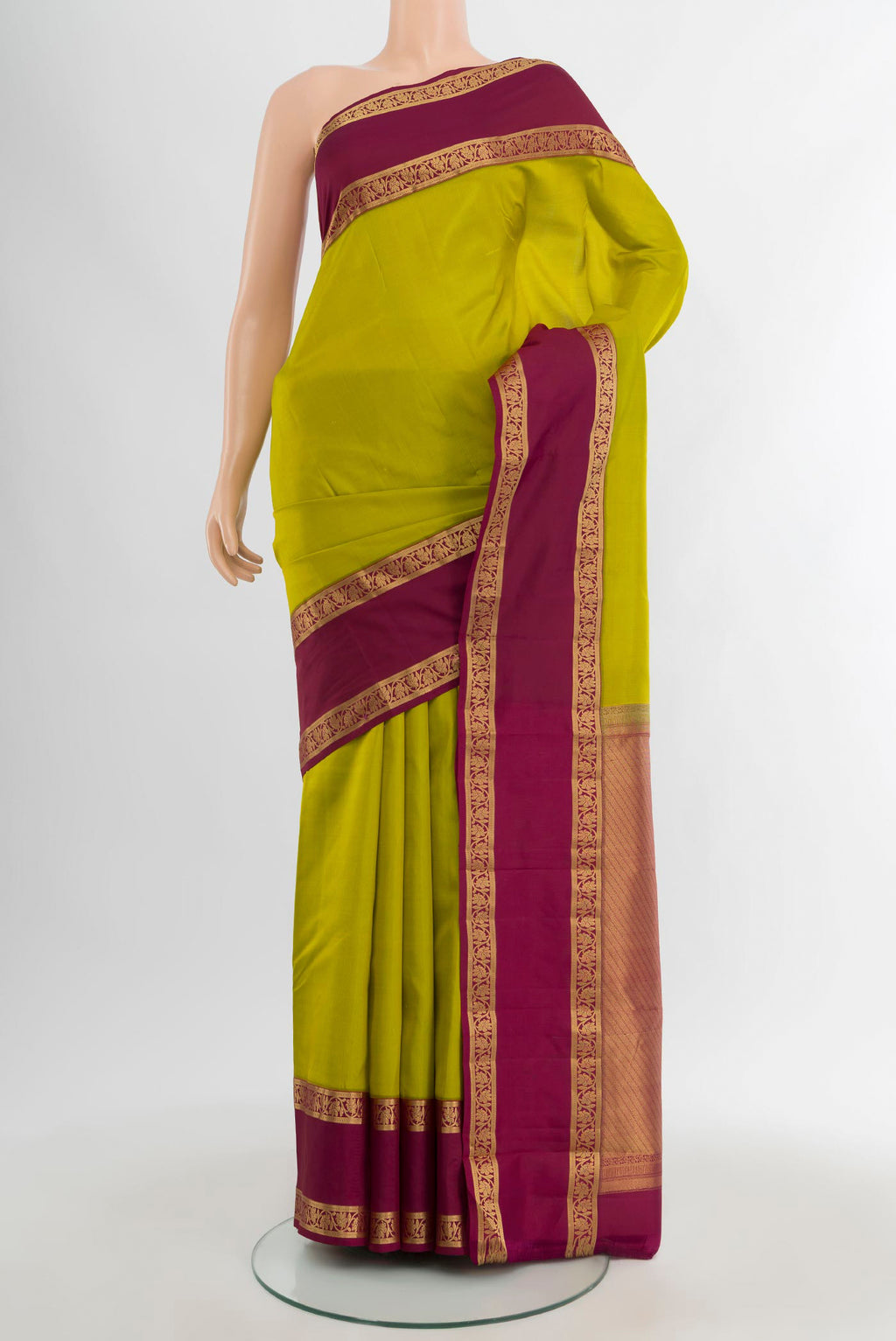 Parrot Green Kanchipuram Silk Saree with Plain Body and Zari Border.  displayed on a mannequin